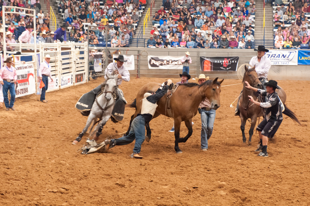 Shaie Williams for AGN Media. Jamie Howlett in trouble during the bareback bronc riding at the Tri State Fair PRCA Rodeo held at Amarillo National Center in Amarillo, TX on September 24, 2016.